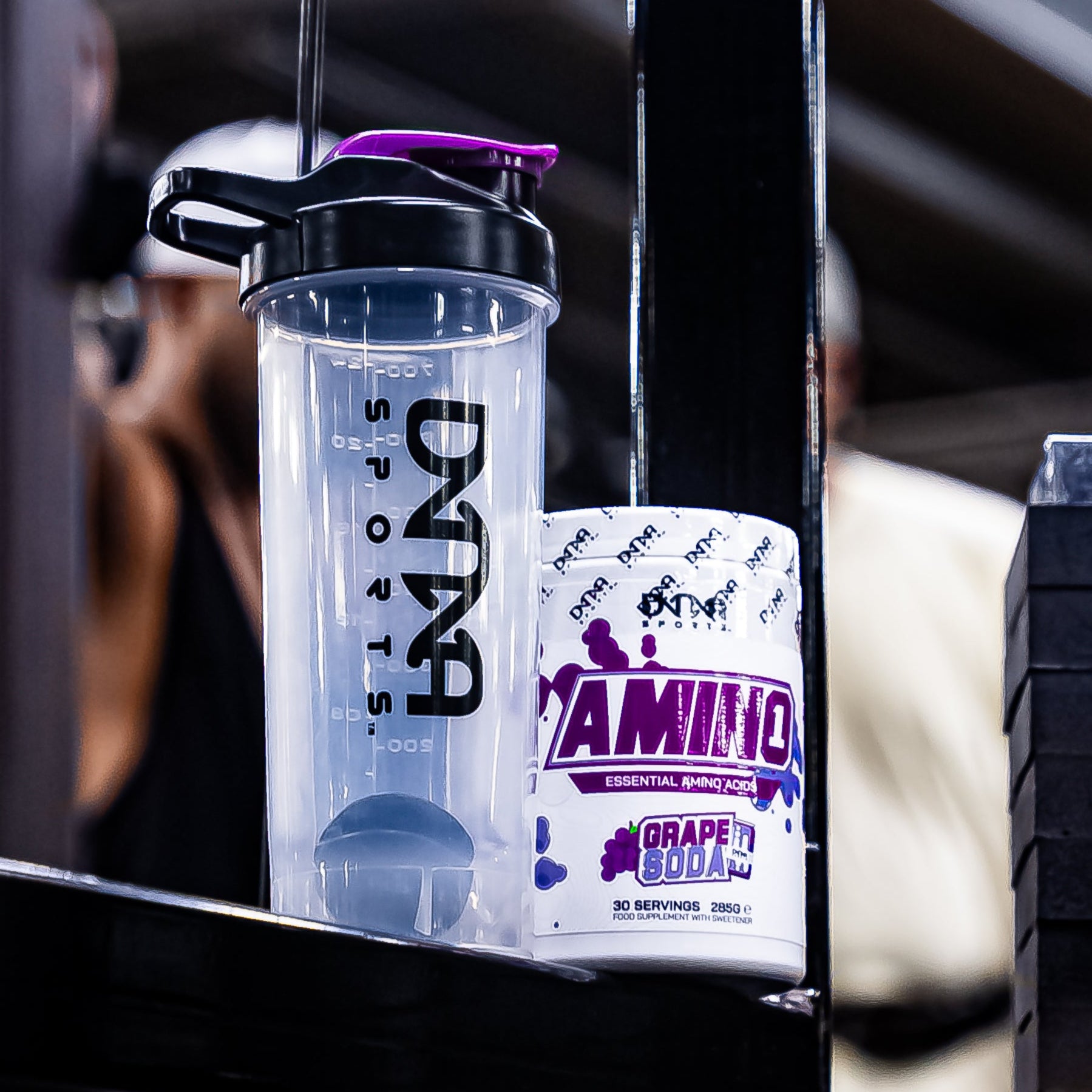 Supplement bottle with purple cap and label on a gym machine.